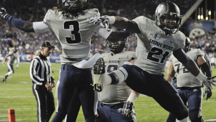 PROVO, UT - OCTOBER 3: Wide receiver Devonte Robinson #3 and LaJuan Hunt #21 of the Utah State Aggies celebrate a touchdown during their 35-20 win over the previously unbeaten Brigham Young Cougars, at LaVell Edwards Stadium on October 3, 2014 in Provo, Utah. (Photo by Gene Sweeney Jr/Getty Images )
