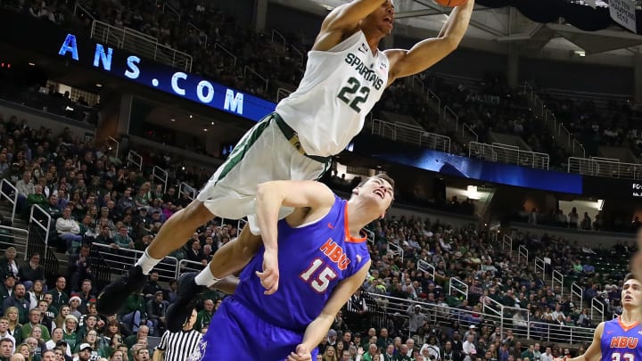 EAST LANSING, MI – DECEMBER 18: Miles Bridges #22 of the Michigan State Spartans dunks over Edward Hardt #15 of the Houston Baptist Huskies during the first half at the Jack T. Breslin Student Events Center on December 18, 2014 in East Lansing, Michigan. Michigan State won the game 107-62. (Photo by Gregory Shamus/Getty Images)