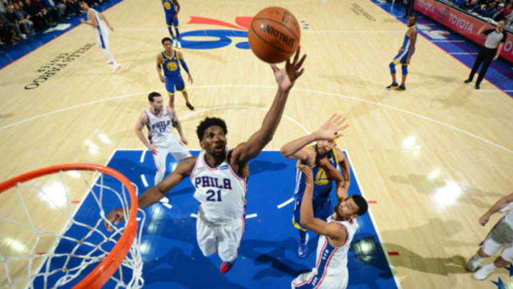 PHILADELPHIA, PA – NOVEMBER 18: Joel Embiid #21 of the Philadelphia 76ers photos the ball during the game against the Golden State Warriors on November 18, 2017 at Wells Fargo Center in Philadelphia, Pennsylvania. NOTE TO USER: User expressly acknowledges and agrees that, by downloading and/or using this Photograph, user is consenting to the terms and conditions of the Getty Images License Agreement. Mandatory Copyright Notice: Copyright 2017 NBAE (Photo by Jesse D. Garrabrant/NBAE via Getty Images)