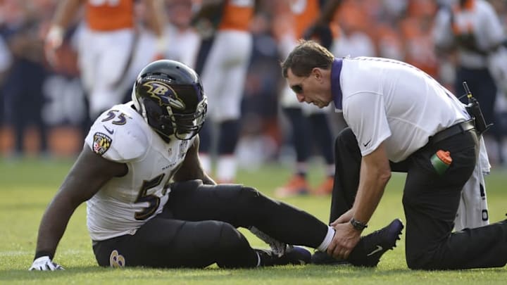 Sep 13, 2015; Denver, CO, USA; Baltimore Ravens outside linebacker Terrell Suggs (55) sits on the ground after an injury to his left lower leg in the fourth quarter against the Denver Broncos at Sports Authority Field at Mile High. The Broncos won 19-13. Mandatory Credit: Ron Chenoy-USA TODAY Sports