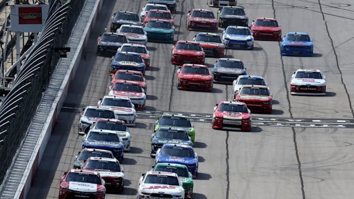 DARLINGTON, SC - SEPTEMBER 02: Denny Hamlin, driver of the #18 Sport Clips Toyota, and Cole Custer, driver of the #00 Haas Automation Ford, lead the field into turn one for a restart during the NASCAR XFINITY Series Sports Clips Haircuts VFW 200 at Darlington Raceway on September 2, 2017 in Darlington, South Carolina. (Photo by Jerry Markland/Getty Images)