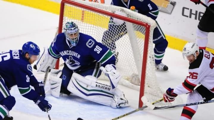 Nov 25, 2014; Vancouver, British Columbia, CAN; Vancouver Canucks forward Jannik Hansen (36) and goaltender Ryan Miller (30) defend against New Jersey Devils forward Patrik Elias (26) during the third period at Rogers Arena.The Vancouver Canucks won 2-0. Mandatory Credit: Anne-Marie Sorvin-USA TODAY Sports