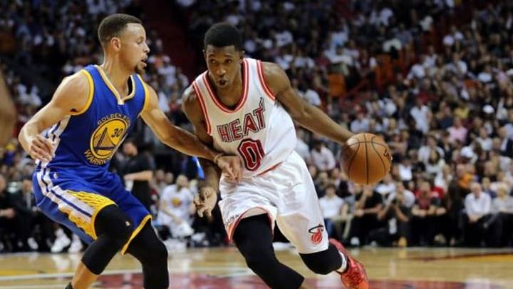 Feb 24, 2016; Miami, FL, USA; Miami Heat guard Josh Richardson (0) drives to the basket as Golden State Warriors guard Stephen Curry (30) defends during the second half at American Airlines Arena. Mandatory Credit: Steve Mitchell-USA TODAY Sports