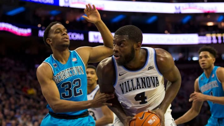 PHILADELPHIA, PA - FEBRUARY 03: Eric Paschall #4 of the Villanova Wildcats controls the ball against Kaleb Johnson #32 of the Georgetown Hoyas in the second half at the Wells Fargo Center on February 3, 2019 in Philadelphia, Pennsylvania. Villanova defeated Georgetown 77-65. (Photo by Mitchell Leff/Getty Images)