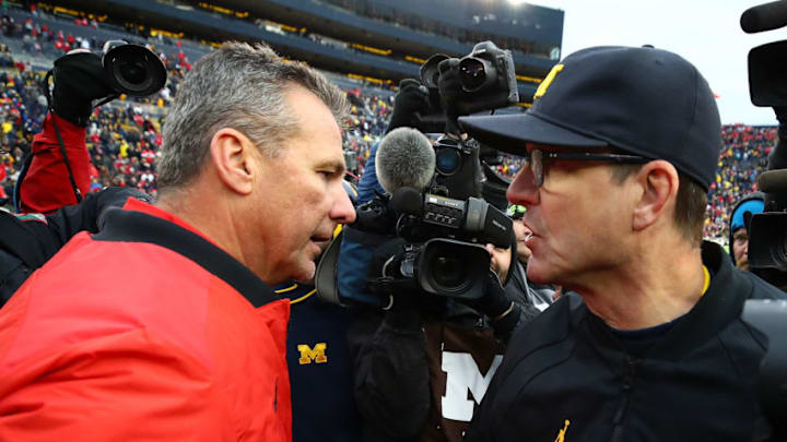 ANN ARBOR, MI - NOVEMBER 25: Urban Meyer head coach of the Ohio State Buckeyes and Jim Harbaugh head coach of the Michigan Wolverines shake hands after the game. Ohio State won 31 to 20 on November 25, 2017 at Michigan Stadium in Ann Arbor, Michigan. (Photo by Gregory Shamus/Getty Images)