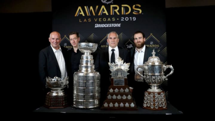 LAS VEGAS, NEVADA - JUNE 19: General manager Doug Armstrong, Jordan Binnington, head coach Craig Berube and Ryan O'Reilly of the St. Louis Blues pose with the Frank J. Selke Trophy, the Stanley Cup, the Conn Smythe Trophy and the Lady Byng Memorial Trophy in the press room at the 2019 NHL Awards at the Mandalay Bay Events Center on June 19, 2019 in Las Vegas, Nevada. (Photo by Bruce Bennett/Getty Images)