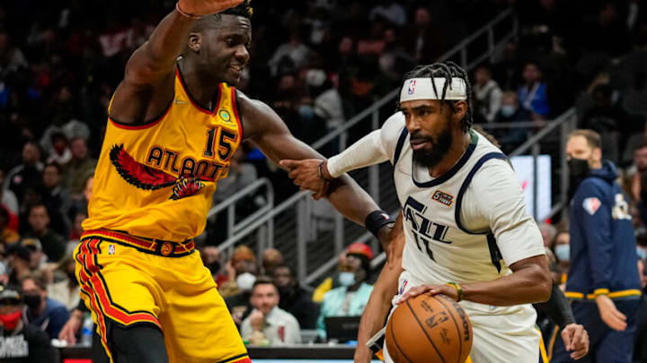 Nov 4, 2021; Atlanta, Georgia, USA; Utah Jazz guard Mike Conley (11) dribbles defended by Atlanta Hawks center Clint Capela (15) during the second half at State Farm Arena. Mandatory Credit: Dale Zanine-USA TODAY Sports