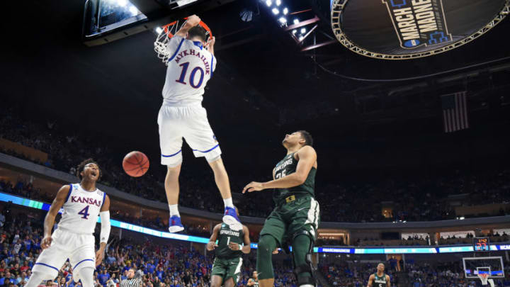 Kansas' Svi Mykhailiuk (10) throws down an alley-oop dunk served up by teammate Devonte' Graham (4) against Michigan State during the first half on Sunday, March 19, 2017 in the second round of the NCAA men's basketball tournament at the BOK Center in Tulsa, Okla. (Rich Sugg/Kansas City Star/TNS via Getty Images)