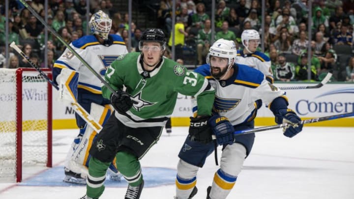 Oct 5, 2023; Dallas, Texas, USA; Dallas Stars center Oskar Back (37) and St. Louis Blues defenseman Nick Leddy (4) chase the puck during the second period at the American Airlines Center. Mandatory Credit: Jerome Miron-USA TODAY Sports