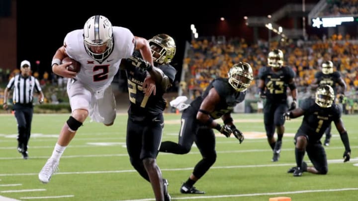 WACO, TX - SEPTEMBER 24: Mason Rudolph #2 of the Oklahoma State Cowboys carries the ball against Verkedric Vaughns #27 of the Baylor Bears in the second half at McLane Stadium on September 24, 2016 in Waco, Texas. (Photo by Tom Pennington/Getty Images)