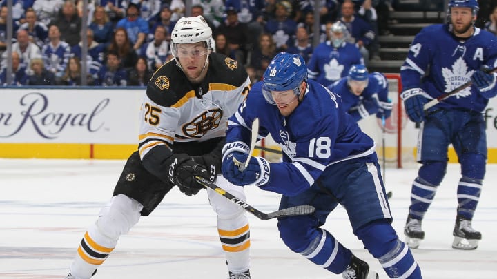 TORONTO, ON – APRIL 21: Brandon Carlo #25 of the Boston Bruins battles against Andreas Johnsson #18 of the Toronto Maple Leafs in Game Six of the Eastern Conference First Round during the 2019 NHL Stanley Cup Playoffs at Scotiabank Arena on April 21, 2019 in Toronto, Ontario, Canada. (Photo by Claus Andersen/Getty Images)