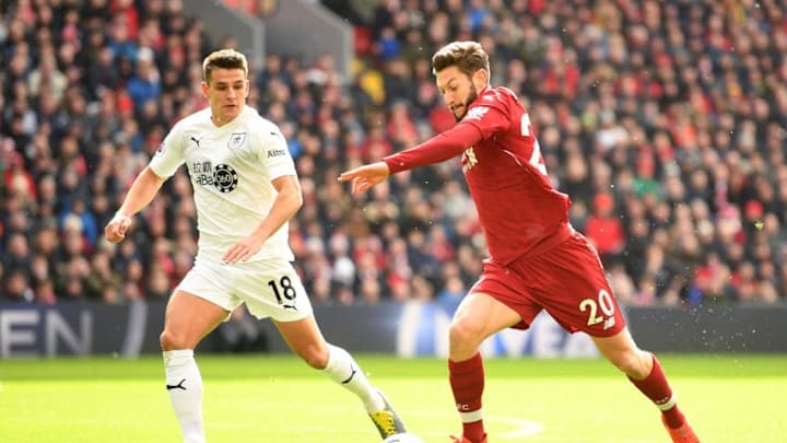 LIVERPOOL, ENGLAND - MARCH 10: Adam Lallana of Liverpool crosses under pressure from Ashley Westwood of Burnley during the Premier League match between Liverpool FC and Burnley FC at Anfield on March 10, 2019 in Liverpool, United Kingdom. (Photo by Michael Regan/Getty Images)