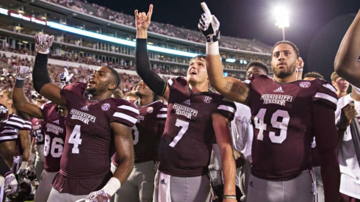 STARKVILLE, MS - SEPTEMBER 10: Nick Fitzgerald #7, Gerri Green #4 and Torrey Dale #49 of the Mississippi State Bulldogs celebrate with fans after a game against the South Carolina Gamecocks at Davis Wade Stadium on September 10, 2016 in Starkville, Mississippi. The Bulldogs defeated the Gamecocks 27-14. (Photo by Wesley Hitt/Getty Images)