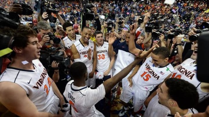 Mar 16, 2014; Greensboro, NC, USA; Virginia Cavaliers guard Teven Jones (5) dances as the Cavaliers celebrate their 72-63 victory over the Duke Blue Devils in the championship game of the ACC college basketball tournament at Greensboro Coliseum. Mandatory Credit: John David Mercer-USA TODAY Sports