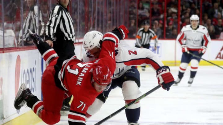 RALEIGH, NC – MARCH 28: Lucas Wallmark #71 of the Carolina Hurricanes is upended by Matt Niskanen #2 of the Washington Capitals during an NHL game on March 28, 2019 at PNC Arena in Raleigh, North Carolina. (Photo by Gregg Forwerck/NHLI via Getty Images)
