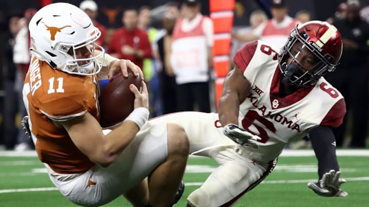 Sam Ehlinger #11 of the Texas Longhorns is tackled by Tre Brown #6 of the Oklahoma Sooners for a safety. (Photo by Ronald Martinez/Getty Images)