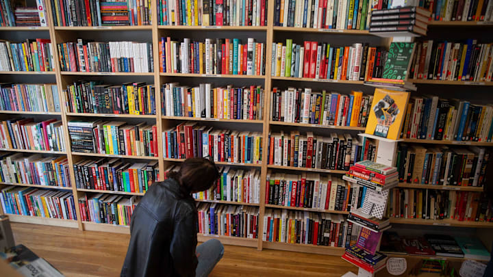 Cat Kuhn of Pittsburg looks over books on offer. The Asbury Book Cooperative is moving across Cookman Avenue to a new location. The move will allow the business to expand and offer more to its customers. Asbury Park, NJFriday, March 11, 2022. Asbury Book Cooperative 1d