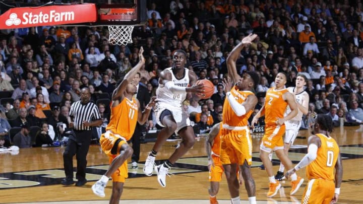 NASHVILLE, TN - JANUARY 23: Simisola Shittu #11 of the Vanderbilt Commodores drives to the basket against Kyle Alexander #11 and Admiral Schofield #5 of the Tennessee Volunteers in the second half of the game at Memorial Gym on January 23, 2019 in Nashville, Tennessee. Tennessee won 88-83 in overtime. (Photo by Joe Robbins/Getty Images)
