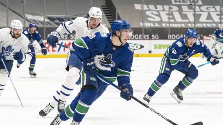 VANCOUVER, BC - APRIL 18: Nils Hoglander #36 of the Vancouver Canucks drives to the next after getting past Auston Matthews #34 of the Toronto Maple Leafs during the second period of NHL hockey action at Rogers Arena on April 17, 2021 in Vancouver, Canada. (Photo by Rich Lam/Getty Images)