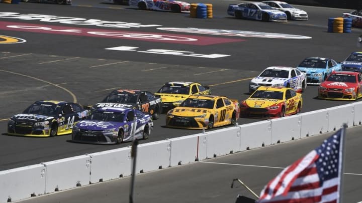 June 26, 2016; Sonoma, CA, USA; Sprint Cup Series driver Tony Stewart (14) and driver Denny Hamlin (11) race during the Toyota Save Mart 350 at Sonoma Raceway. Mandatory Credit: Kyle Terada-USA TODAY Sports