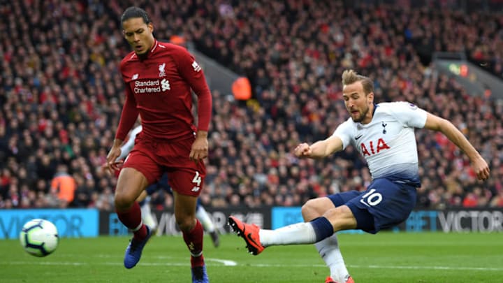 LIVERPOOL, ENGLAND - MARCH 31: Harry Kane of Tottenham Hotspur shoots under pressure from Virgil Van Dijk of Liverpool during the Premier League match between Liverpool FC and Tottenham Hotspur at Anfield on March 31, 2019 in Liverpool, United Kingdom. (Photo by Shaun Botterill/Getty Images)