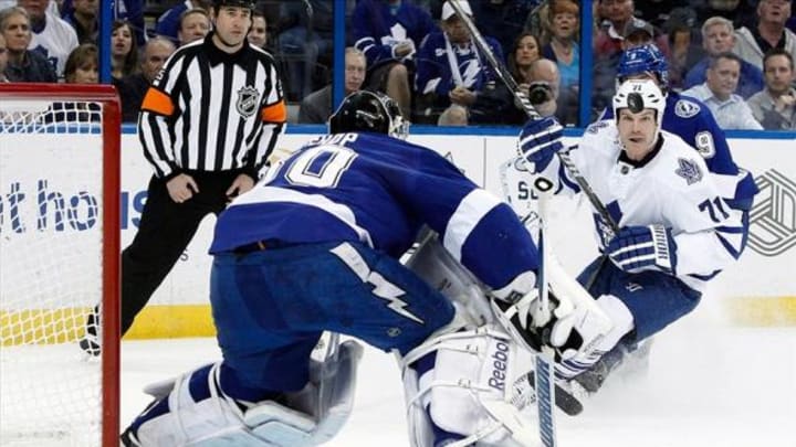 Feb 6, 2014; Tampa, FL, USA; Toronto Maple Leafs right wing David Clarkson (71) looks at the puck as Tampa Bay Lightning goalie Ben Bishop (30) defends during the first period at Tampa Bay Times Forum. Mandatory Credit: Kim Klement-USA TODAY Sports
