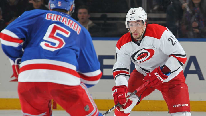 NEW YORK, NY – DECEMBER 21: Justin Faulk #27 of the Carolina Hurricanes skates with the puck against Dan Girardi #5 of the New York Rangers at Madison Square Garden on December 21, 2014 in New York City. The New York Rangers won 1-0. (Photo by Jared Silber/NHLI via Getty Images)