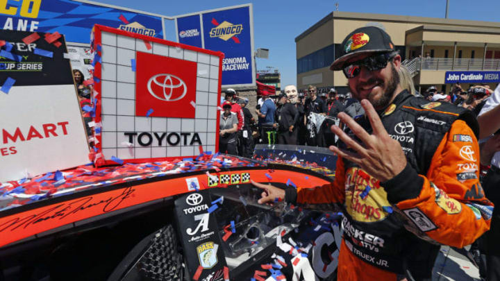 SONOMA, CALIFORNIA - JUNE 23: Martin Truex Jr., driver of the #19 Bass Pro Shops Toyota, poses with the winner’s decal on his car in Victory Lane after winning the Monster Energy NASCAR Cup Series Toyota/Save Mart 350 at Sonoma Raceway on June 23, 2019 in Sonoma, California. (Photo by Jonathan Ferrey/Getty Images)