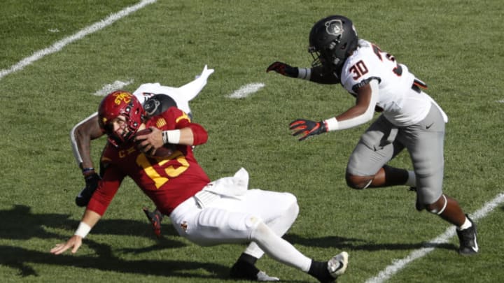 AMES, IA - OCTOBER 23: Quarterback Brock Purdy #15 of the Iowa State Cyclones is sacked by linebacker Devin Harper #16 of the Oklahoma State Cowboys in the first half at Jack Trice Stadium on October 23, 2021 in Ames, Iowa. (Photo by David Purdy/Getty Images)