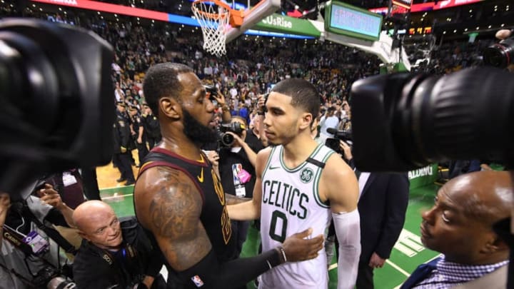 LeBron James (23) of the Cleveland Cavaliers and Jayson Tatum (0) of the Boston Celtics after Cleveland won game seven  of the Eastern Conference Finals 87-79 (Photo by Brian Babineau/NBAE via Getty Images)