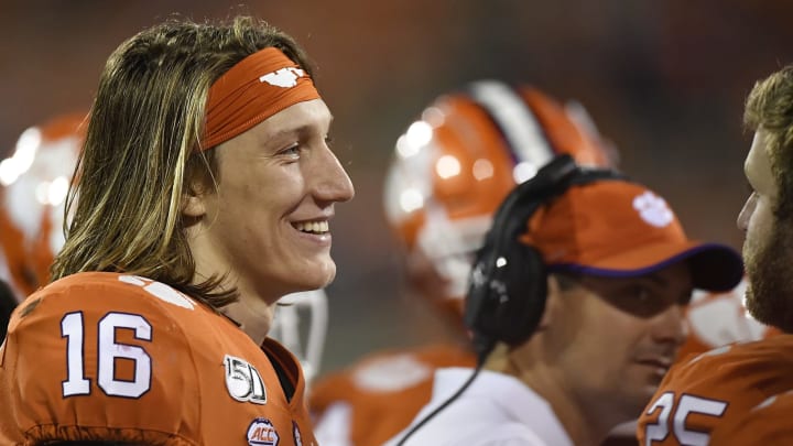 CLEMSON, SOUTH CAROLINA – OCTOBER 26: Quarterback Trevor Lawrence #16 of the Clemson Tigers talks with teammates on the sideline during the Tigers’ football game against the Boston College Eagles at Memorial Stadium on October 26, 2019 in Clemson, South Carolina. (Photo by Mike Comer/Getty Images)