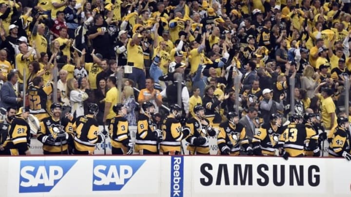 Jun 9, 2016; Pittsburgh, PA, USA; Pittsburgh Penguins fans cheer behind the bench in the first period game five of the 2016 Stanley Cup Final against the San Jose Sharks at Consol Energy Center. Mandatory Credit: Don Wright-USA TODAY Sports