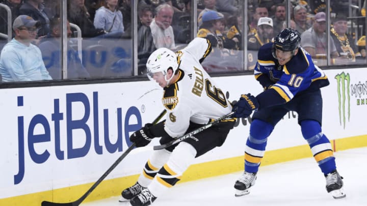 Nov 7, 2022; Boston, Massachusetts, USA; Boston Bruins defenseman Mike Reilly (6) controls the puck away from St. Louis Blues center Brayden Schenn (10) during the second period at TD Garden. Mandatory Credit: Bob DeChiara-USA TODAY Sports
