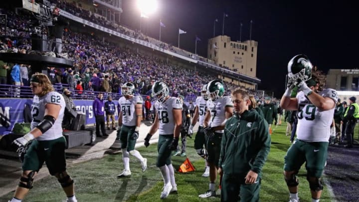 EVANSTON, IL - OCTOBER 28: Members of the Michigan State Spartans walk off of the field after a loss to the Northwestern Wildcats at Ryan Field on October 28, 2017 in Evanston, Illinois. Northwestern defeated Michigan State 39-31 in triple overtime.(Photo by Jonathan Daniel/Getty Images)