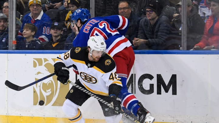 Feb 15, 2022; New York, New York, USA; New York Rangers center Filip Chytil (72) and Boston Bruins defenseman Matt Grzelcyk (48) battle for the puck behind the net during the first period at Madison Square Garden. Mandatory Credit: Dennis Schneidler-USA TODAY Sports