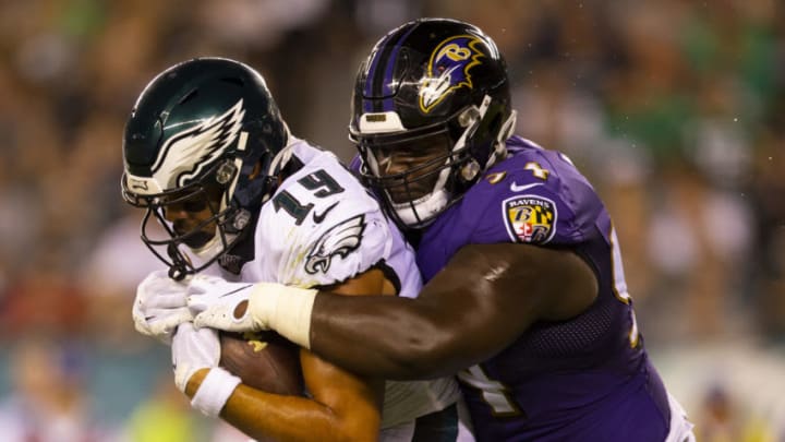 PHILADELPHIA, PA - AUGUST 22: J.J. Arcega-Whiteside #19 of the Philadelphia Eagles catches a pass and is tackled by Daylon Mack #94 of the Baltimore Ravens in the second quarter of the preseason game at Lincoln Financial Field on August 22, 2019 in Philadelphia, Pennsylvania. (Photo by Mitchell Leff/Getty Images)