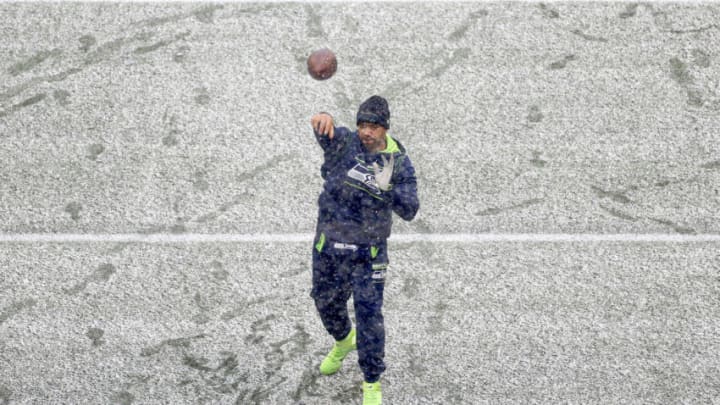 SEATTLE, WASHINGTON - DECEMBER 26: Russell Wilson #3 of the Seattle Seahawks warms up in the snow before the game against the Chicago Bears at Lumen Field on December 26, 2021 in Seattle, Washington. (Photo by Steph Chambers/Getty Images)