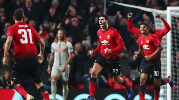 Marouane Fellaini celebrates with team mates Marcus Rashford and Romelu Lukaku after scoring the winner against Young Boys