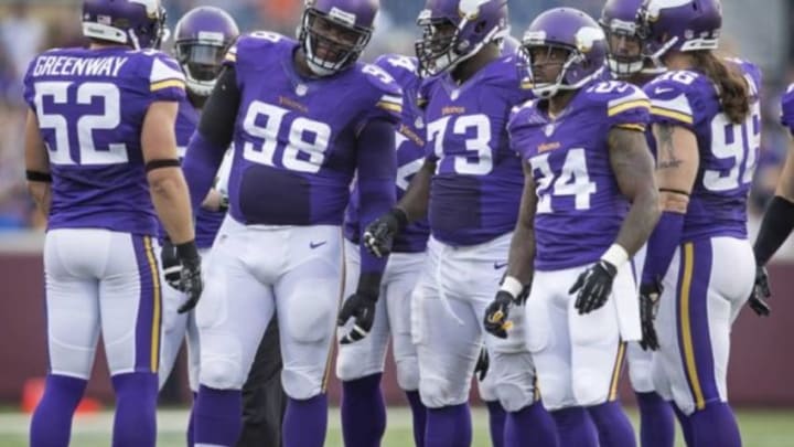 Aug 8, 2014; Minneapolis, MN, USA; Minnesota Vikings defensive tackle Linval Joseph (98) and defensive tackle Sharrif Floyd (73) and cornerback Captain Munnerlyn (24) get ready for the Oakland Raiders to play at TCF Bank Stadium. Vikings win 10-6. Mandatory Credit: Bruce Kluckhohn-USA TODAY Sports