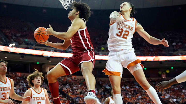 Jan 11, 2022; Austin, Texas, USA; Oklahoma Sooners forward Jalen Hill (1) drives to the basket past Texas Longhorns forward Christian Bishop (32) during the second half at Frank C. Erwin Jr. Center. Mandatory Credit: Scott Wachter-USA TODAY Sports