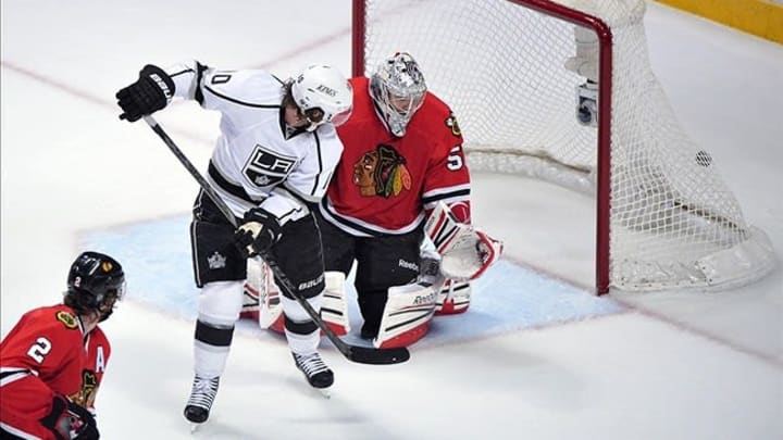 Jun 8, 2013; Chicago, IL, USA; Los Angeles Kings center Mike Richards (10) scores a goal past Chicago Blackhawks goalie Corey Crawford (50) during the third period in game five of the Western Conference finals of the 2013 Stanley Cup Playoffs at the United Center. Mandatory Credit: Scott Stewart-USA TODAY Sports