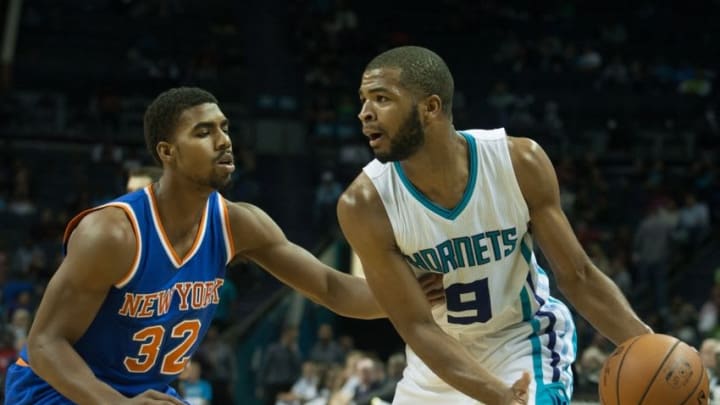 Oct 17, 2015; Charlotte, NC, USA; Charlotte Hornets guard Aaron Harrison (9) looks to pass the ball while New York Knicks guard Wesley Saunders (32) defends at Time Warner Cable Arena. The Hornets defeated the Knicks 97-93. Mandatory Credit: Jeremy Brevard-USA TODAY Sports