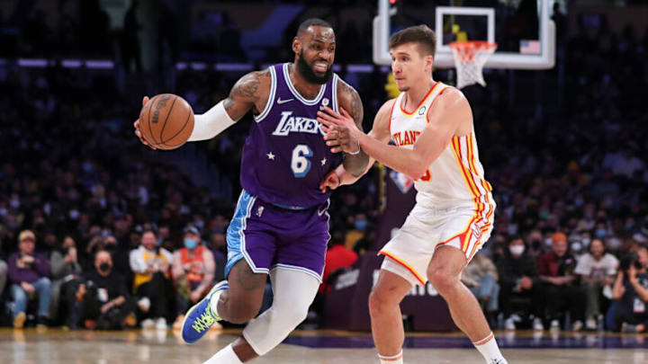 LOS ANGELES, CALIFORNIA - JANUARY 07: LeBron James #6 of the Los Angeles Lakers handles the ball defended by Bogdan Bogdanovic #13 of the Atlanta Hawks in the second half at Crypto.com Arena on January 07, 2022 in Los Angeles, California. NOTE TO USER: User expressly acknowledges and agrees that, by downloading and or using this photograph, User is consenting to the terms and conditions of the Getty Images License Agreement. (Photo by Meg Oliphant/Getty Images)