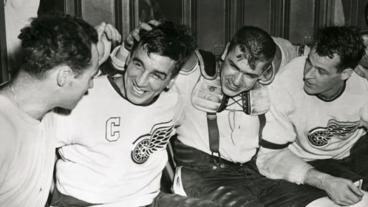 (Original Caption) This Quartet of Detroit Red Wings make merry in their dressing room after they scored the goals that sent the Maple Leafs down to a 5-4 defeat in overtime play. For the Detroiters it meant a 3-0 lead in the semifinals of the National Hockey League Playoffs. Left to right are Red Kelly, Ted Lindsay, Metro Prystiol and Gordie Howe.
