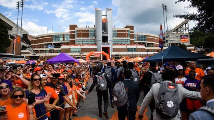 Clemson fans cheer as coaches and players walk off the bus towards Memorial Stadium during the Tiger Walk Saturday, Sept. 18, 2021.Jm Tigerwalk 091721 005