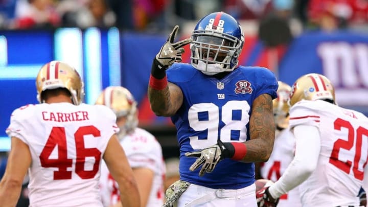 EAST RUTHERFORD, NJ - NOVEMBER 16: Damontre Moore #98 of the New York Giants celebrates after a tackle against the San Francisco 49ers at MetLife Stadium on November 16, 2014 in East Rutherford, New Jersey. (Photo by Elsa/Getty Images)