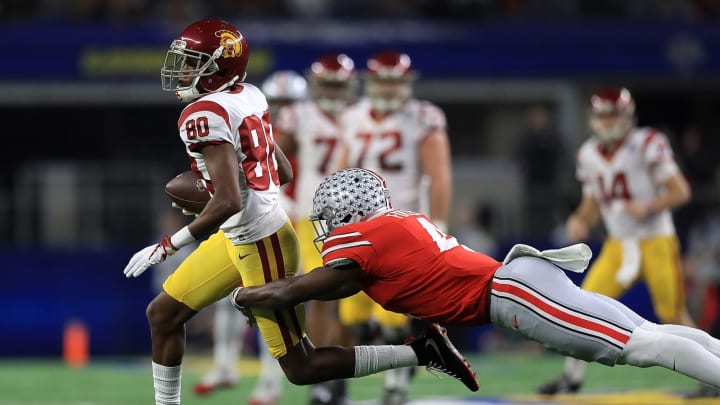 ARLINGTON, TX – DECEMBER 29: Deontay Burnett #80 of the USC Trojans runs the ball against Jordan Fuller #4 of the Ohio State Buckeyes in the second quarter during the Goodyear Cotton Bowl at AT&T Stadium on December 29, 2017 in Arlington, Texas. (Photo by Ronald Martinez/Getty Images)