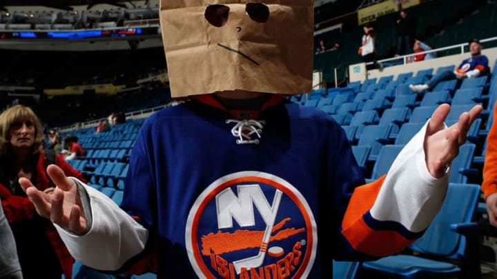 UNIONDALE, NY - NOVEMBER 26: A dejected fan shows his feelings towards the team as he hides his face prior to the game between the New Jersey Devils and the New York Islanders on November 26, 2010 at Nassau Coliseum in Uniondale, New York. (Photo by Mike Stobe/NHLI via Getty Images)