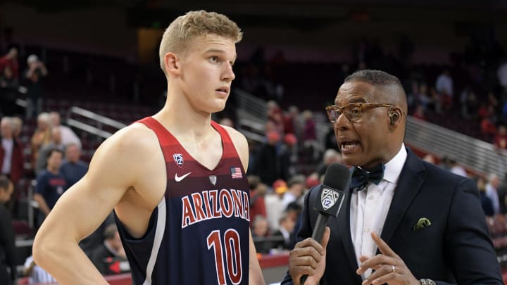 Jan 19, 2017; Los Angeles, CA, USA; Pac-12 Networks broadcaster Lewis Johnson (right) interviews Arizona Wildcats forward Lauri Markkanen (10) after a NCAA basketball against the Southern California Trojans at Galen Center. Arizona defeated USC 73-66. Mandatory Credit: Kirby Lee-USA TODAY Sports