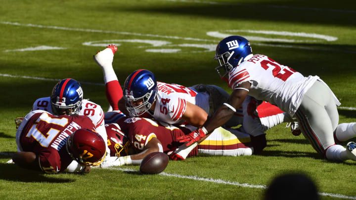 Nov 8, 2020; Landover, Maryland, USA; New York Giants safety Jabrill Peppers (21) recovers a fumble by Washington Football Team running back Antonio Gibson (24) during the first quarter at FedExField. Mandatory Credit: Brad Mills-USA TODAY Sports